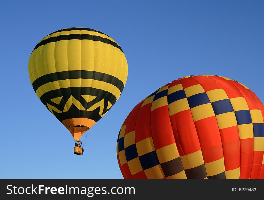 Yellow and red hot air balloons in the blue sky. Yellow and red hot air balloons in the blue sky.