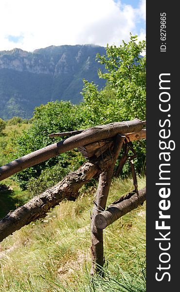 A fence of wood and a mountain. A fence of wood and a mountain