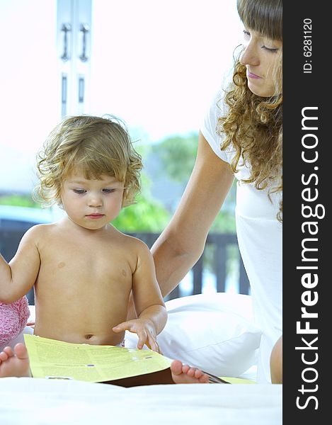 High key portrait  of young baby getting busy with the book. High key portrait  of young baby getting busy with the book