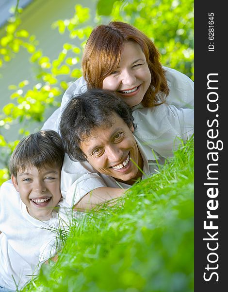 Portrait of young happy family in summer environment