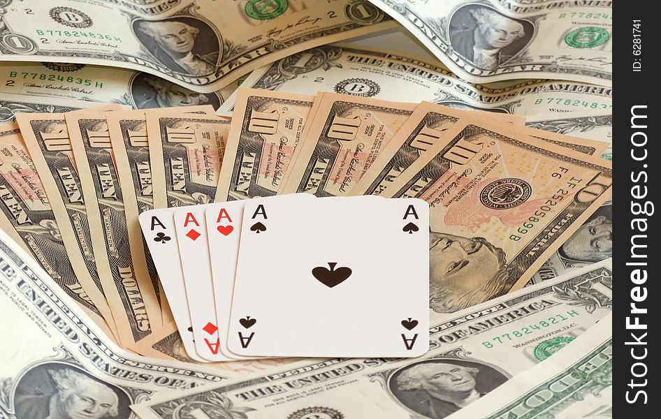 Four aces against background made of dollars