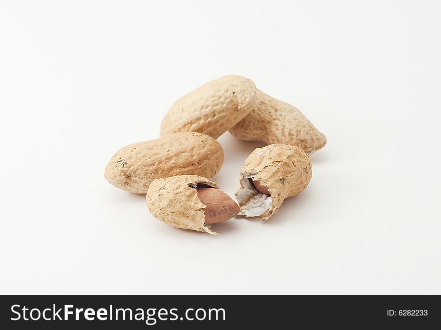 Group of peanuts; one of them is cracked. Group of peanuts; one of them is cracked.