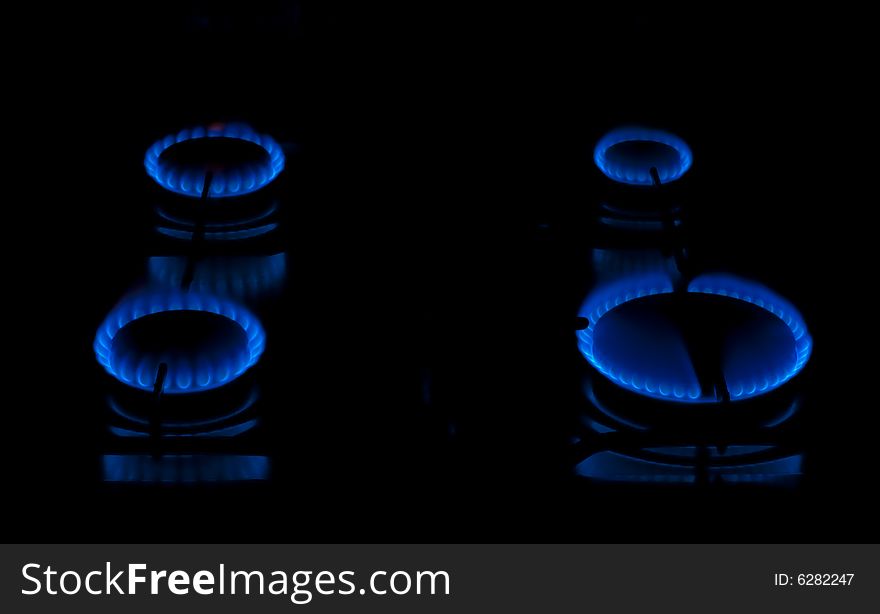 Kitchen burners on, showing blue flames. Kitchen burners on, showing blue flames.