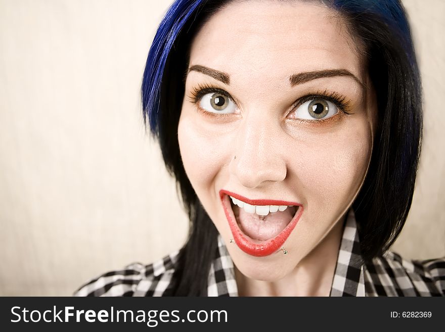 Wide angle portrait of a cute rockabilly woman laughing. Wide angle portrait of a cute rockabilly woman laughing