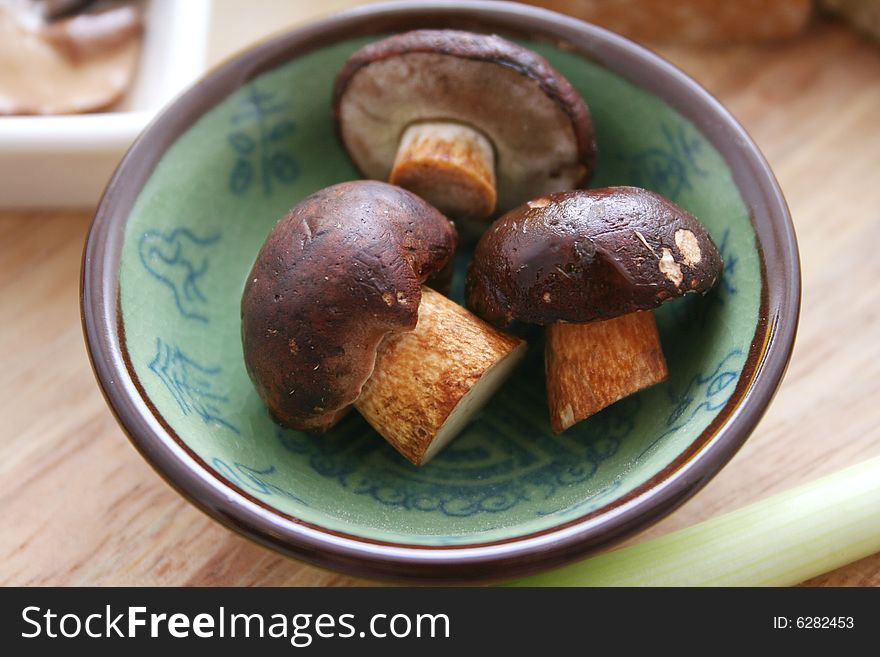 Some fresh mushrooms in beautiful table ware