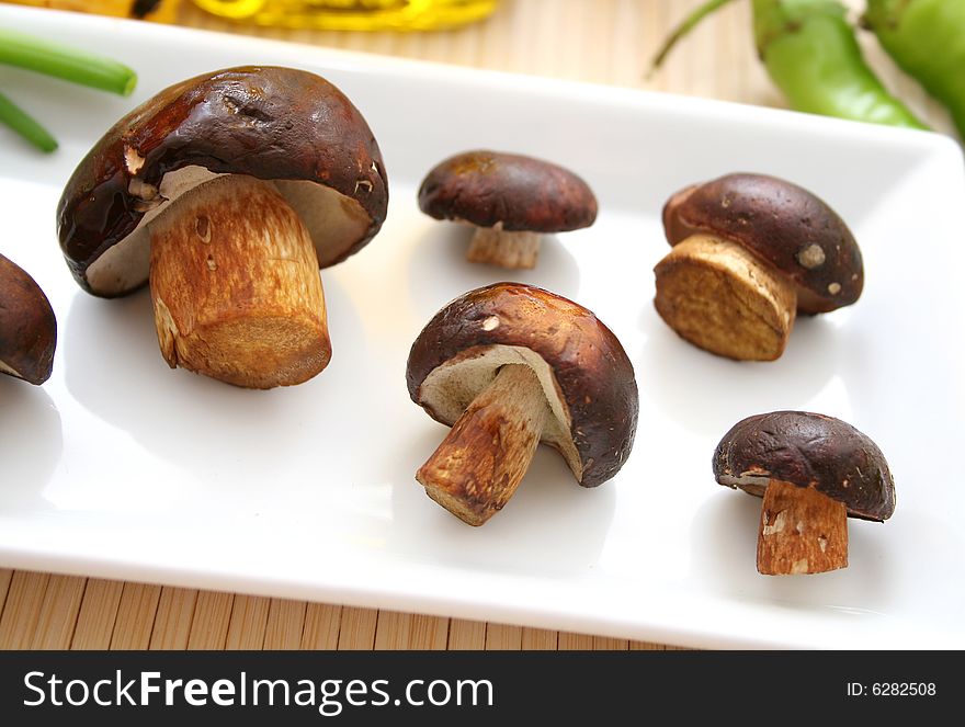 Some fresh mushrooms in beautiful table ware