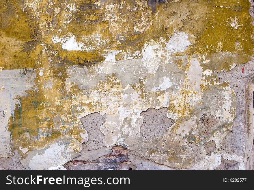 Closeup of grey old wall with peeled stucco and stains. Closeup of grey old wall with peeled stucco and stains