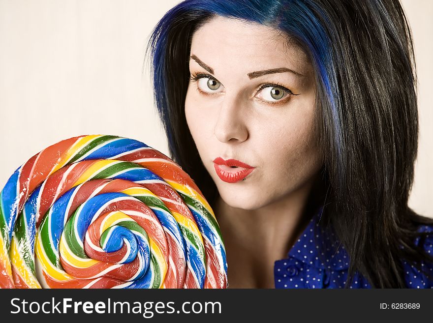 Pretty woman with big eyes and a large lollipop. Pretty woman with big eyes and a large lollipop