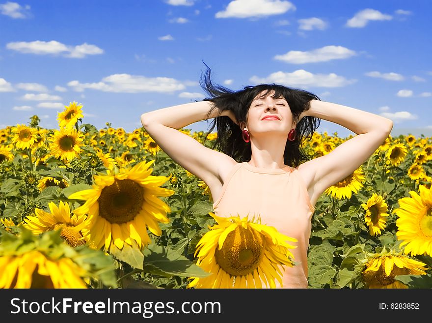 Fun woman in the field of sunflowers