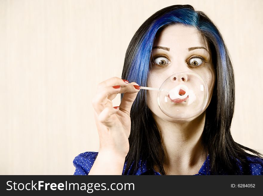 Pretty with Crossed Eyes Woman Blowing a Large Bubble. Pretty with Crossed Eyes Woman Blowing a Large Bubble