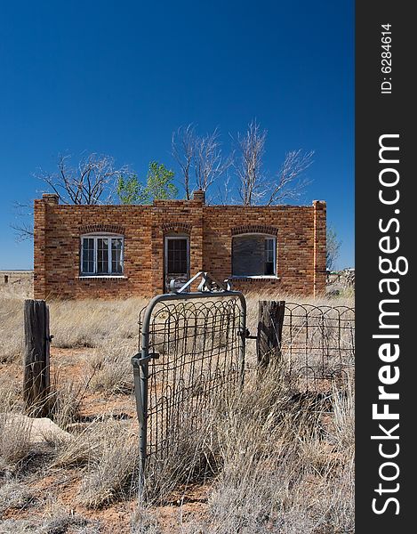 An image of a rustic brick house in the desert