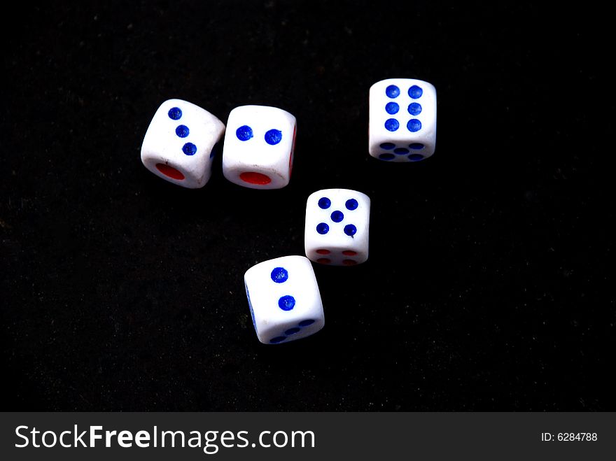 Five Dices  with blue dots on the black background. Five Dices  with blue dots on the black background.
