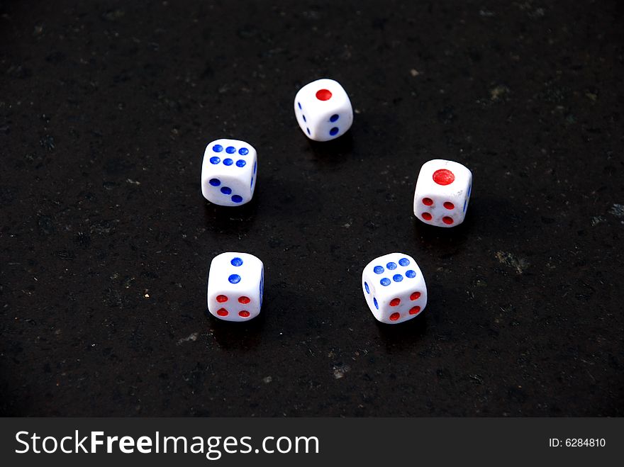 Five Dices with red and blue dots on the black background. Five Dices with red and blue dots on the black background.