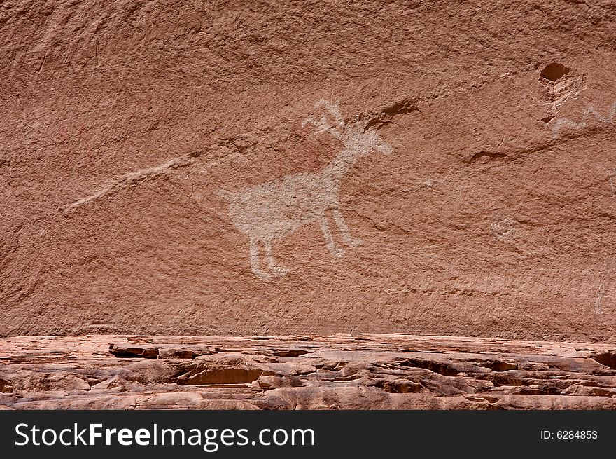 An image of carvings and ancient art on canyon walls