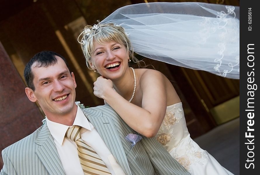 Happy laughing bride and groom outdoor