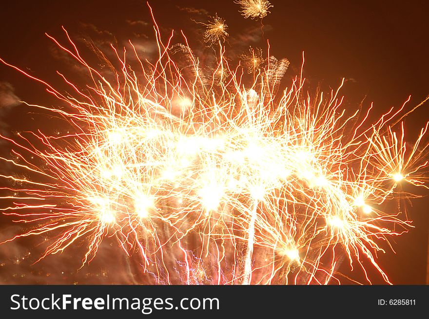 A background of lit fireworks on the celebration of the Independence day. A background of lit fireworks on the celebration of the Independence day.