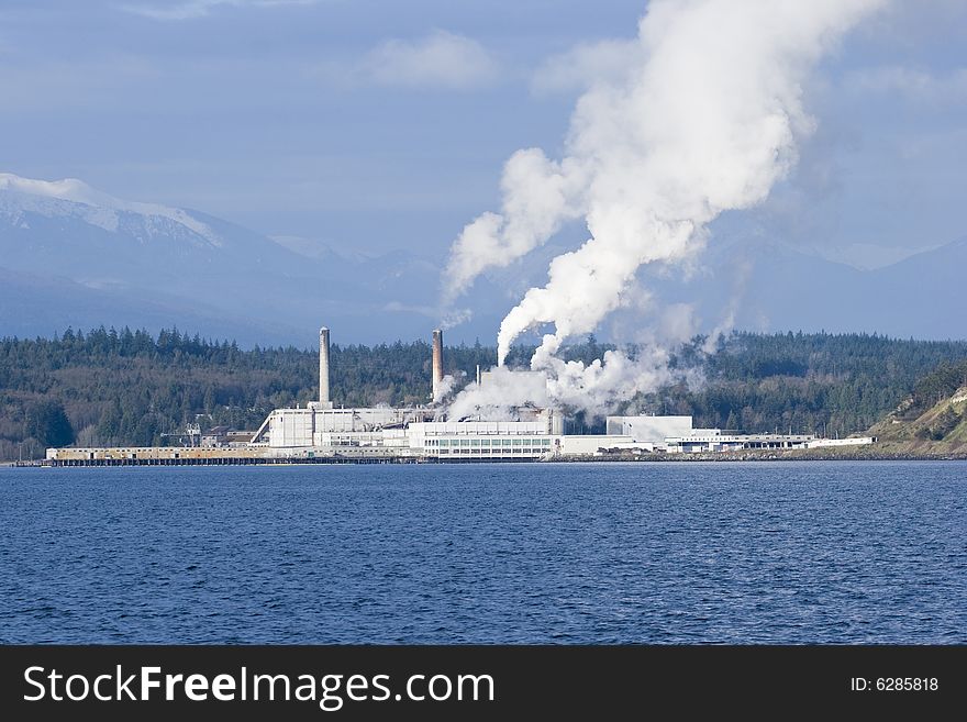 Factory or plant with billowing smoke. Factory or plant with billowing smoke