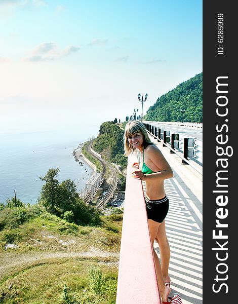 Girl to rest in banisters of the car bridge on seascapes