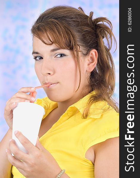 Young woman drinks lemonade isolated