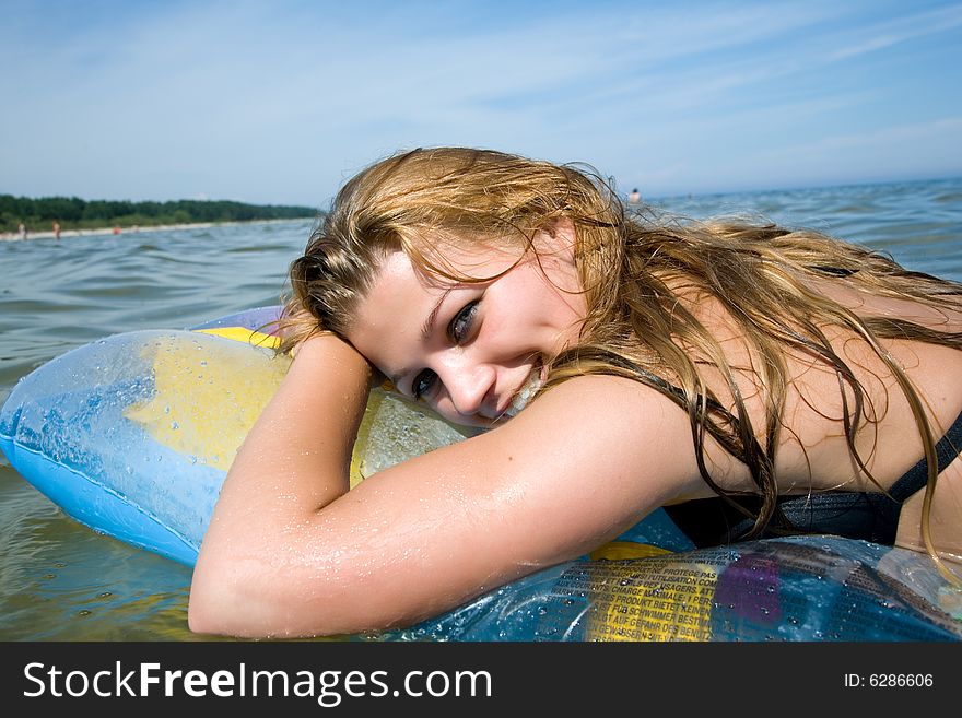 Beautiful girl swiming on air-mattress in sea. Beautiful girl swiming on air-mattress in sea