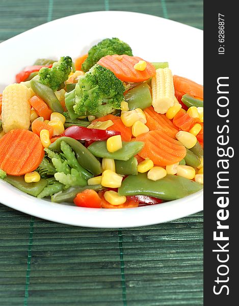 Cooked carrots sweet corn and broccoli on plate. Cooked carrots sweet corn and broccoli on plate