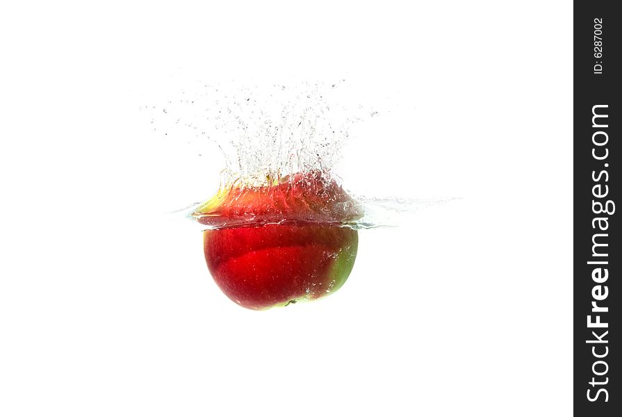 Ripe red apple falling in water. Ripe red apple falling in water