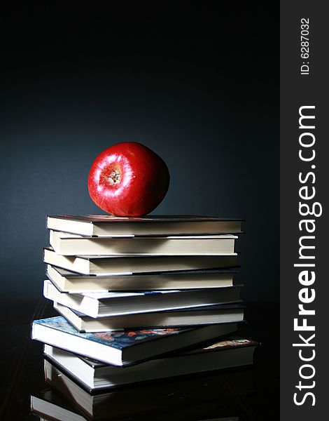 Books and red apple. School concept.