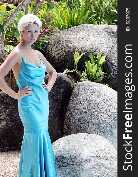 Gorgeous blond woman wearing a blue evening gown.