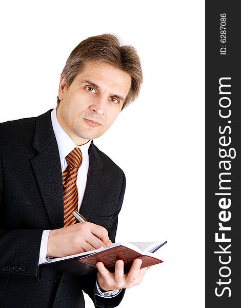 Businessman writing something in his notebook. Businessman writing something in his notebook