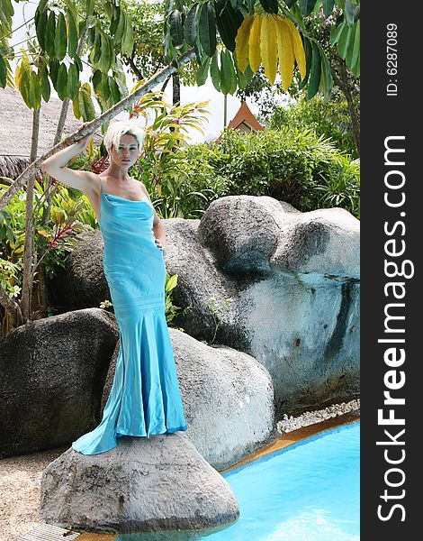 Gorgeous blond woman wearing a blue evening gown.