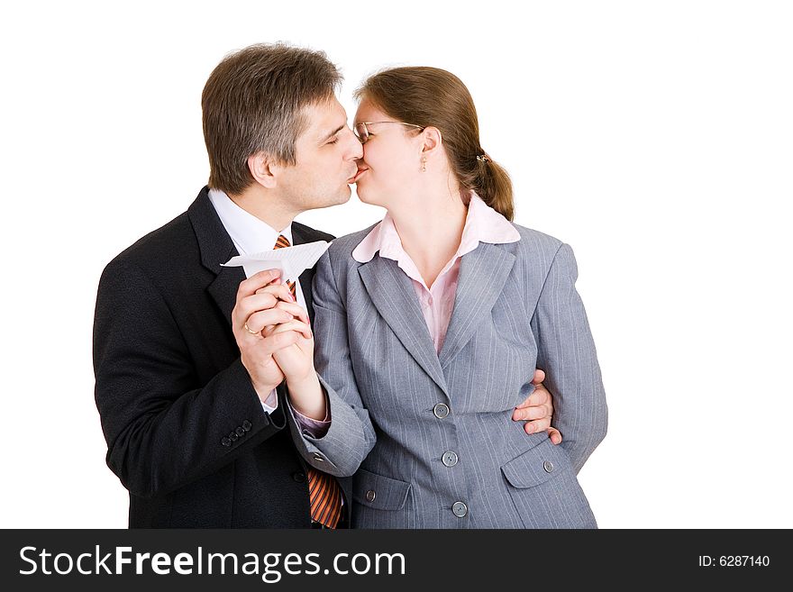 Business man and woman kiss with paper airplane in hands. Business man and woman kiss with paper airplane in hands