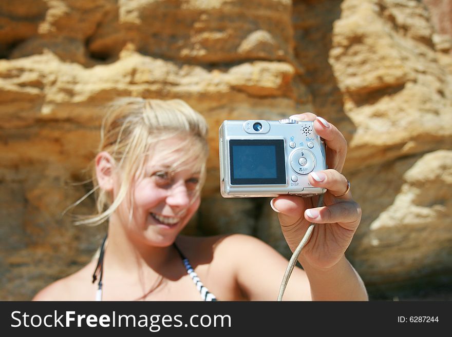 Girl with a camera in beach