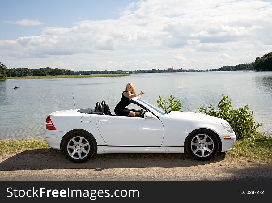 Portrait of the beautiful young girl on nature with cabriolet. Portrait of the beautiful young girl on nature with cabriolet