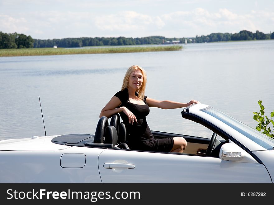 Portrait of the beautiful young girl on nature with cabriolet. Portrait of the beautiful young girl on nature with cabriolet