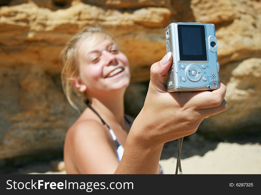 Girl with a camera in beach
