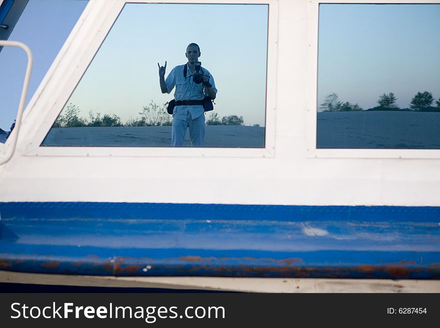 Reflexion of the photographer in the window of the ship. Reflexion of the photographer in the window of the ship