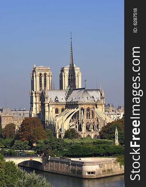 France, Paris: nice city view from the quai of the seine river; blue sky, green trees and the Seine river for this view of Paris with Notre Dame cathedral on the background. France, Paris: nice city view from the quai of the seine river; blue sky, green trees and the Seine river for this view of Paris with Notre Dame cathedral on the background