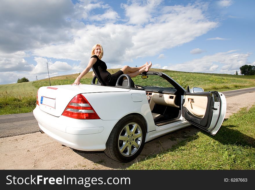 Portrait of the beautiful young girl on nature with cabriolet. Portrait of the beautiful young girl on nature with cabriolet