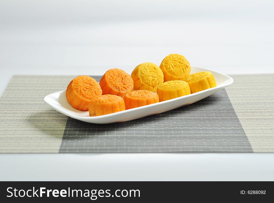 Pictures of orange and yellow skinned mooncakes. Picture here, ready to serve. Good for festival, asian and chinese contexts. Pictures of orange and yellow skinned mooncakes. Picture here, ready to serve. Good for festival, asian and chinese contexts.