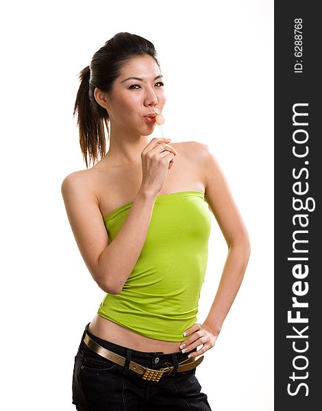 Young asian woman having fun with lollipop