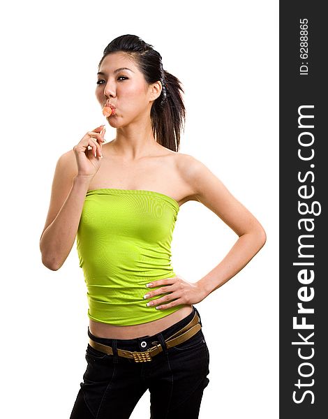 Young asian woman having fun eating lollipop. Young asian woman having fun eating lollipop