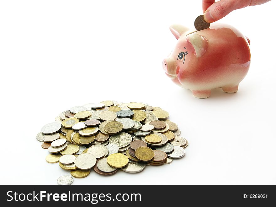 Pink piggy bank  isolated on white background with coins. Pink piggy bank  isolated on white background with coins