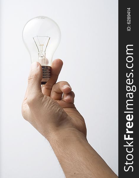 Human hand and light bulb isolated over white