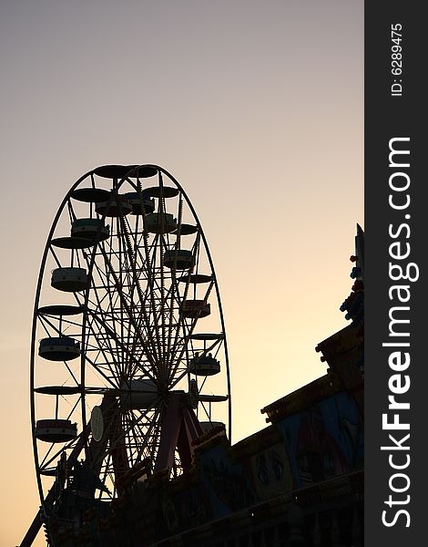 Silhouette of the ferris wheel at the dusk.