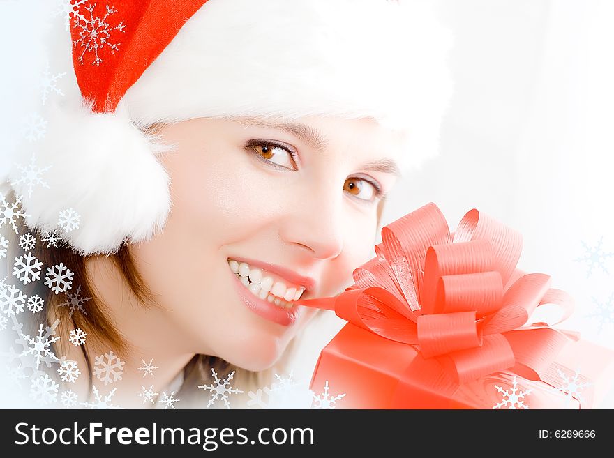 Winter portrait of a smiling woman with a gift