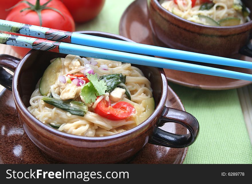 A japanese meal of udon noodles, vegetables and meat. A japanese meal of udon noodles, vegetables and meat