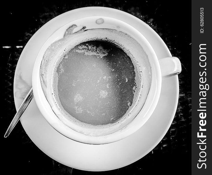 White classic teacup with herbal refreshment tea on the table. White classic teacup with herbal refreshment tea on the table