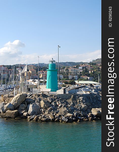 Green lighthouse in the harbour of Porto Maurizio, Liguria in Italy