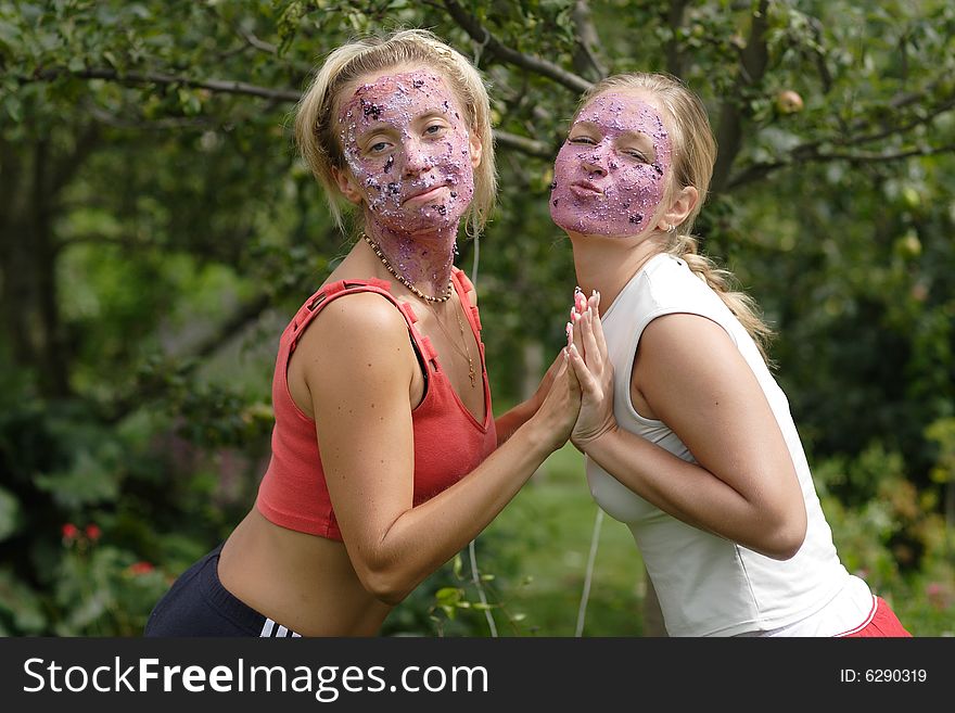 Two girls with a fruit mask on the face