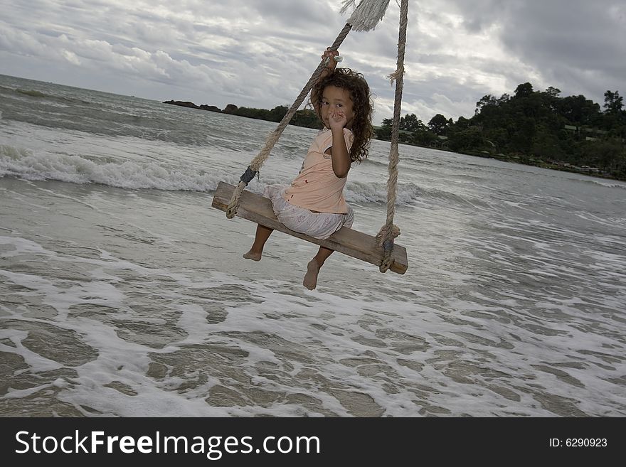 Girl On Swing At The Sea